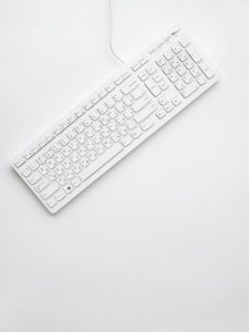 A modern white keyboard on a white background showcasing minimalist design and clean aesthetics.